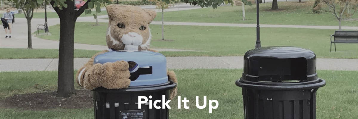 The UK mascot hugging a recycling bin. Text at the bottom of the image reads "Pick it up"
