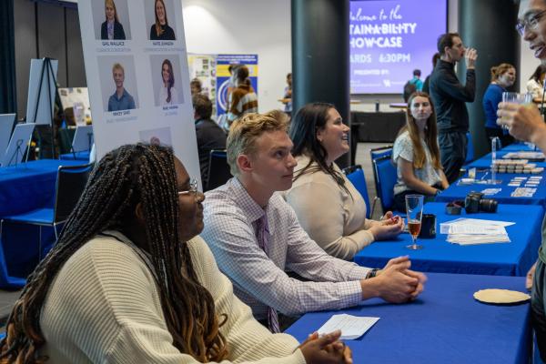 Showcase attendees interacting with exhibitors