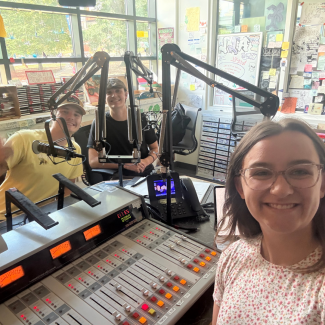 Students pose at the WRFL DJ station