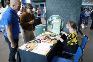 Exhibitor displays table of bioplastics at showcase